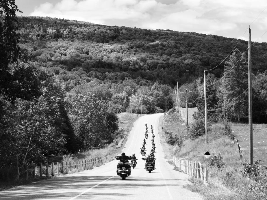 motorcycle-caravan-rides-hillside-in-black-and-white