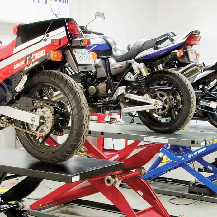 row of motorcyclees on lifts